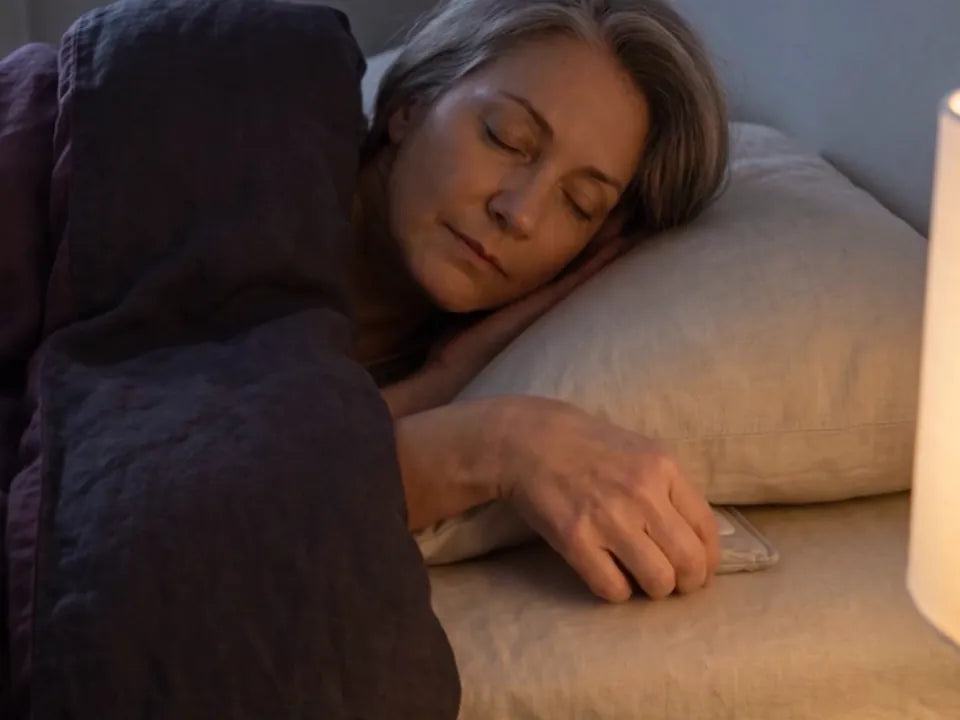 She slides the speaker under the pillow
