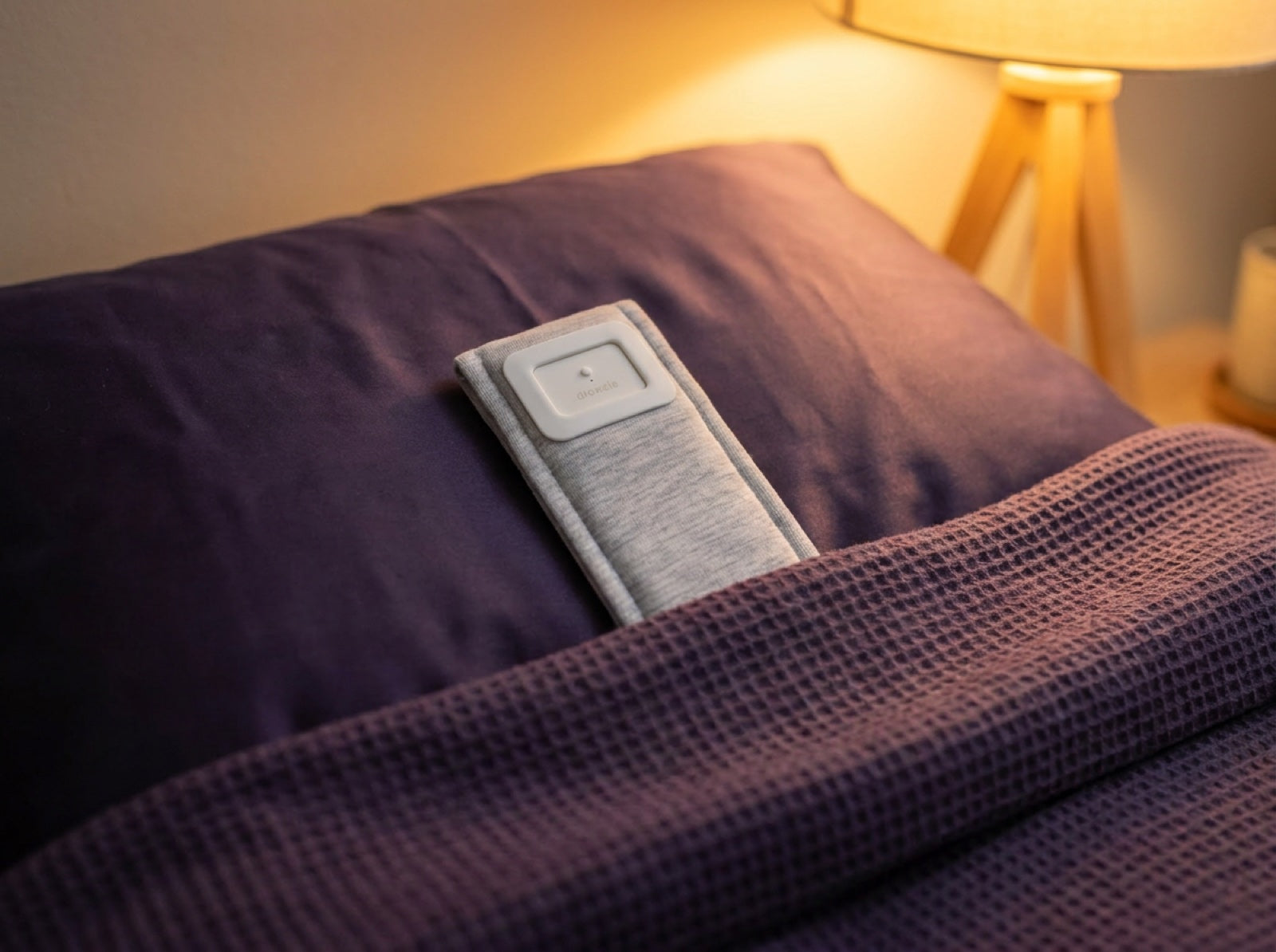 The Drowsie V3 speaker lying flat under a pillow